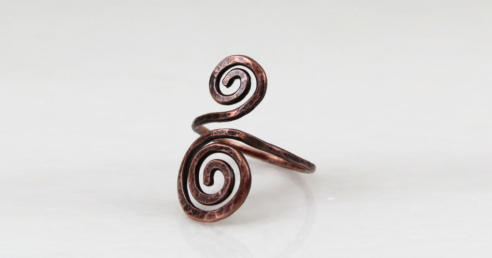 Miedziany pierścionek luźno inspirowany dawną biżuterią słowiańską. Pierścionek został w całości wykonany z miedzi, jego faktura została lekko podkreślona ciemną patyną uzyskaną w procesie oksydacji